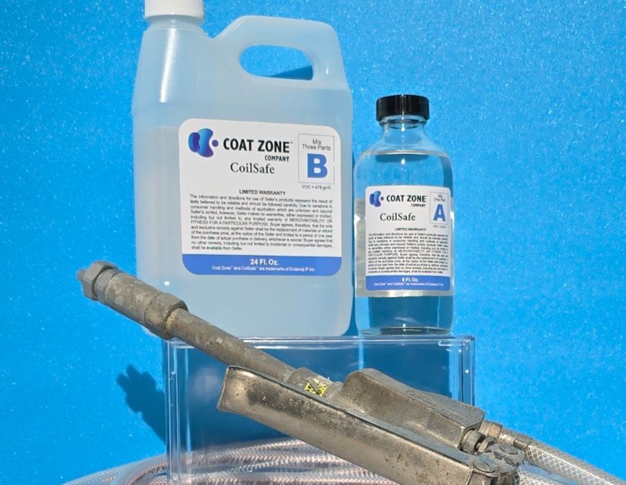 Bottles of Coat Zone products, including Caustic B, with spray equipment in front of a blue background.