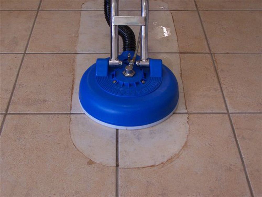 A blue vacuum cleaner is sitting on a tiled floor