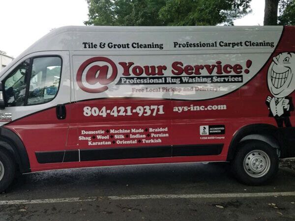 A red and white van that says your service on the side