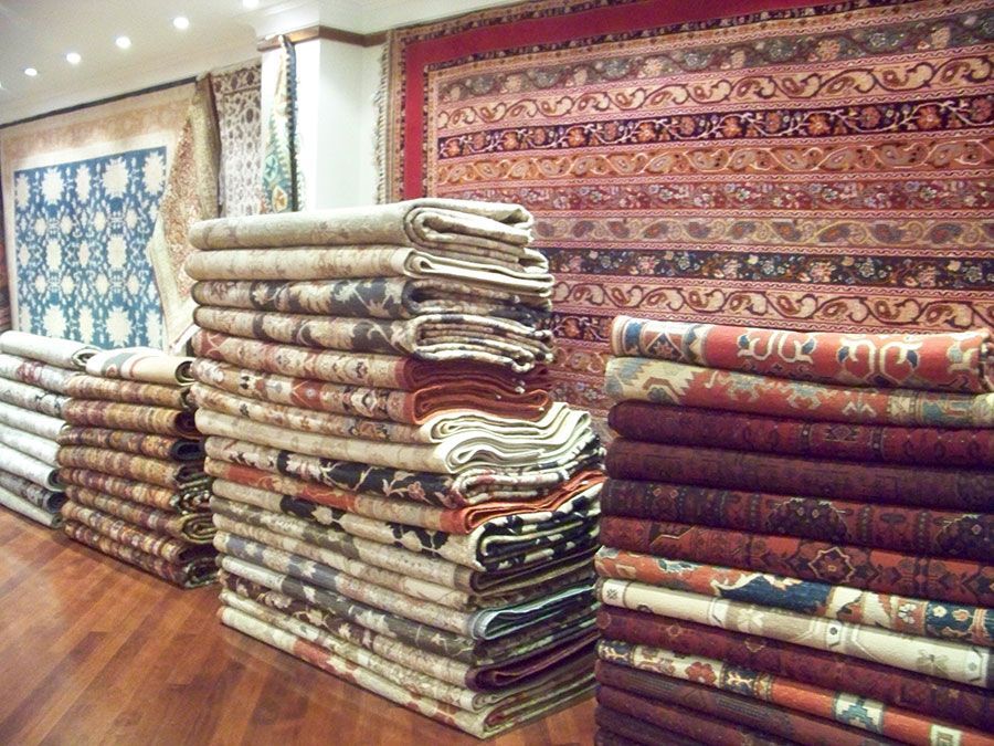 A bunch of rugs are stacked on top of each other