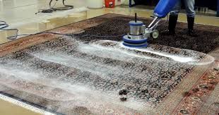 A person is cleaning a rug with a machine.
