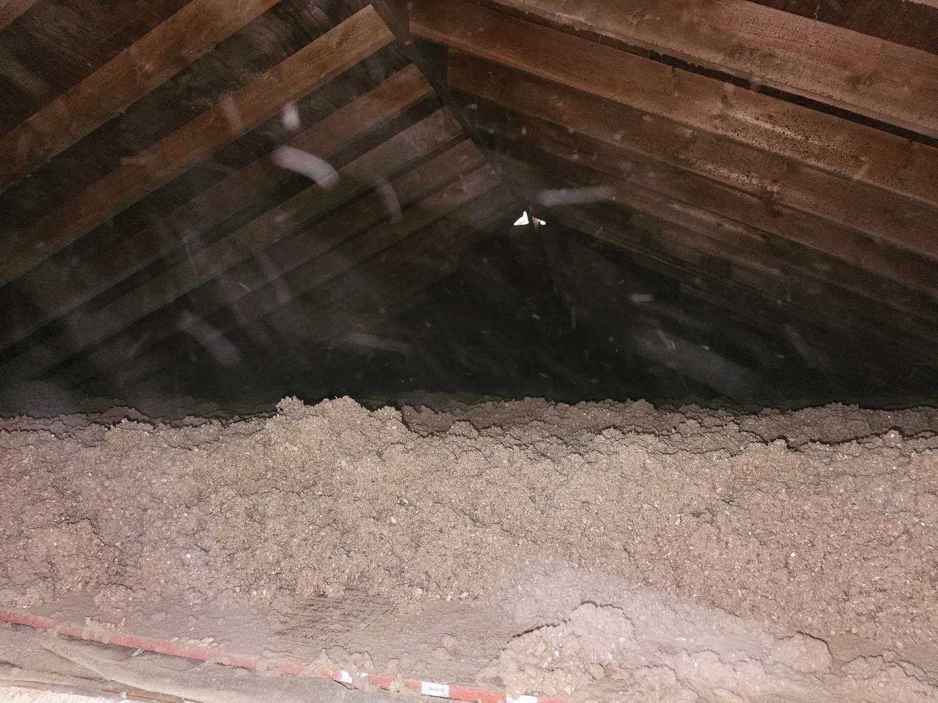 There is a lot of insulation in the attic of a house.