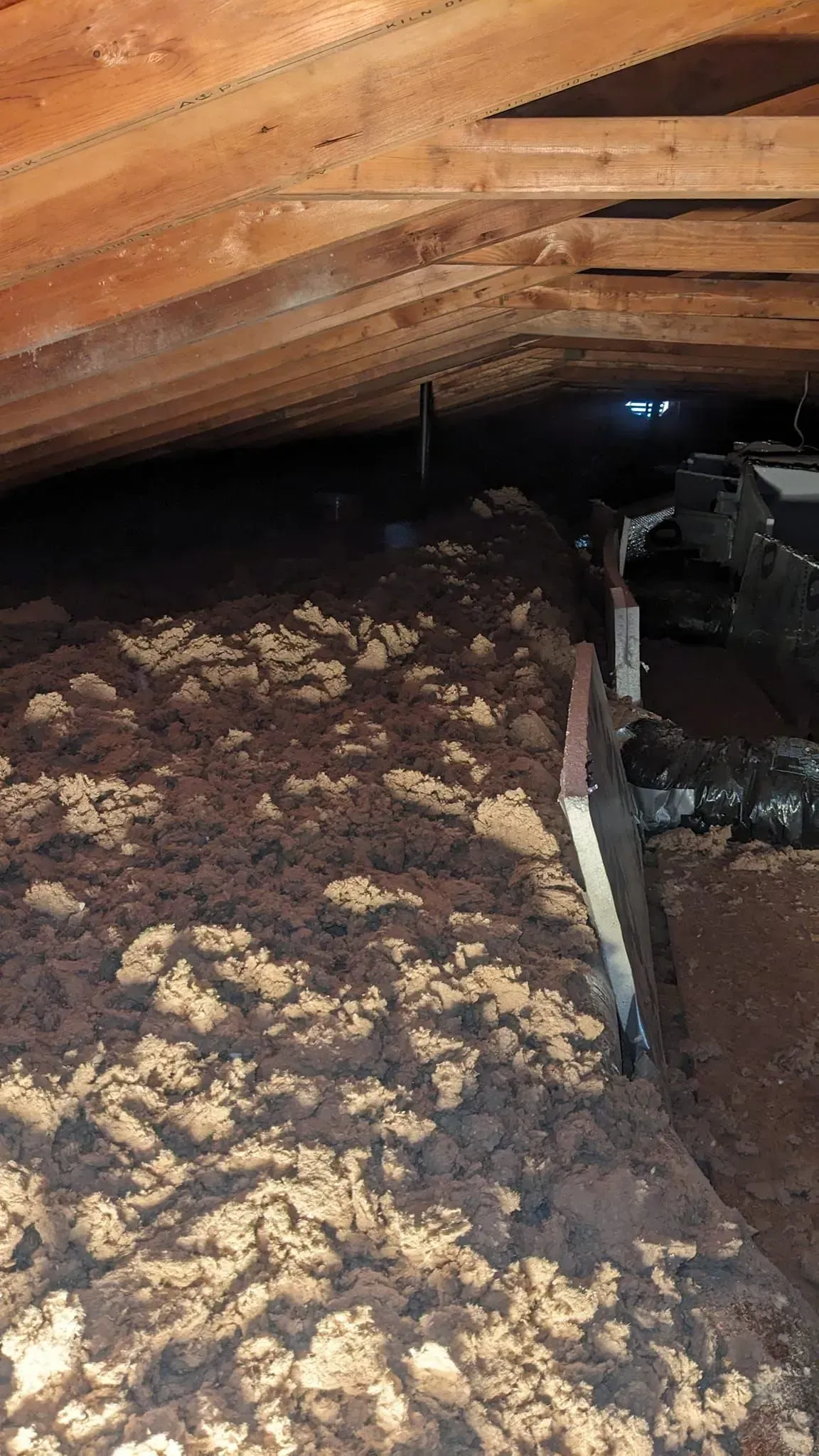 There is a lot of dirt in the attic of a house.