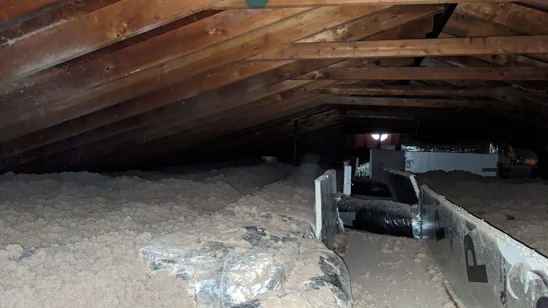 There is a lot of wood in the attic of a house.
