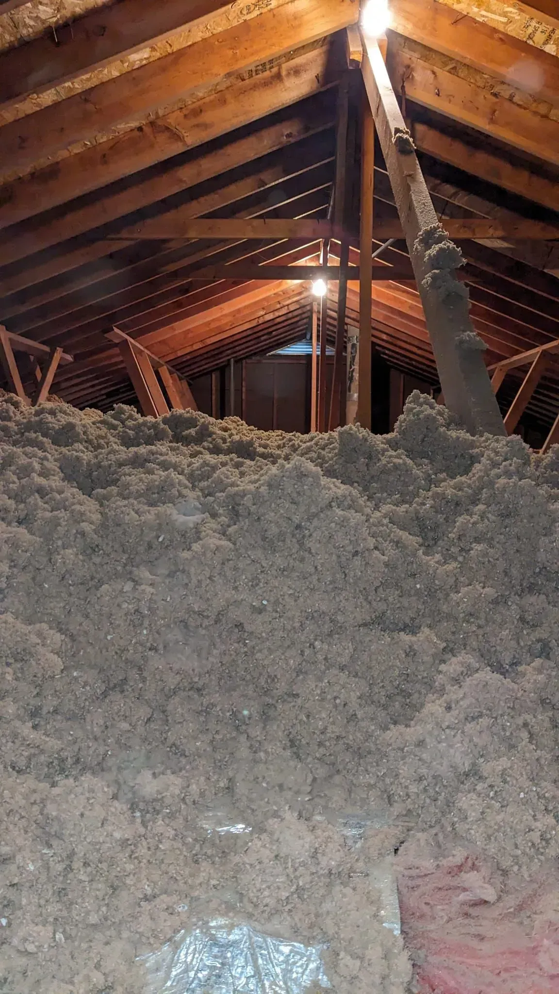 There is a lot of insulation in the attic of a house.