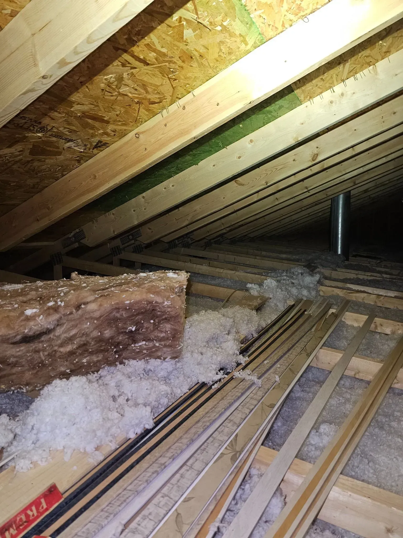 There is a lot of wood in the attic of a house.
