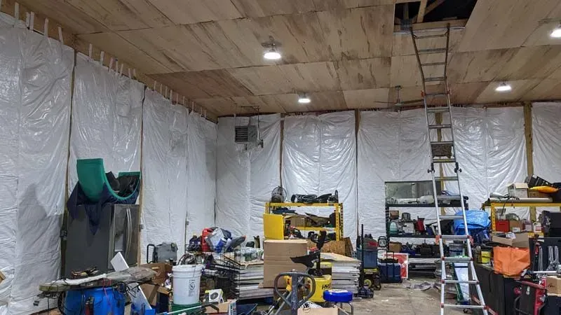 A garage filled with lots of tools and a ladder.