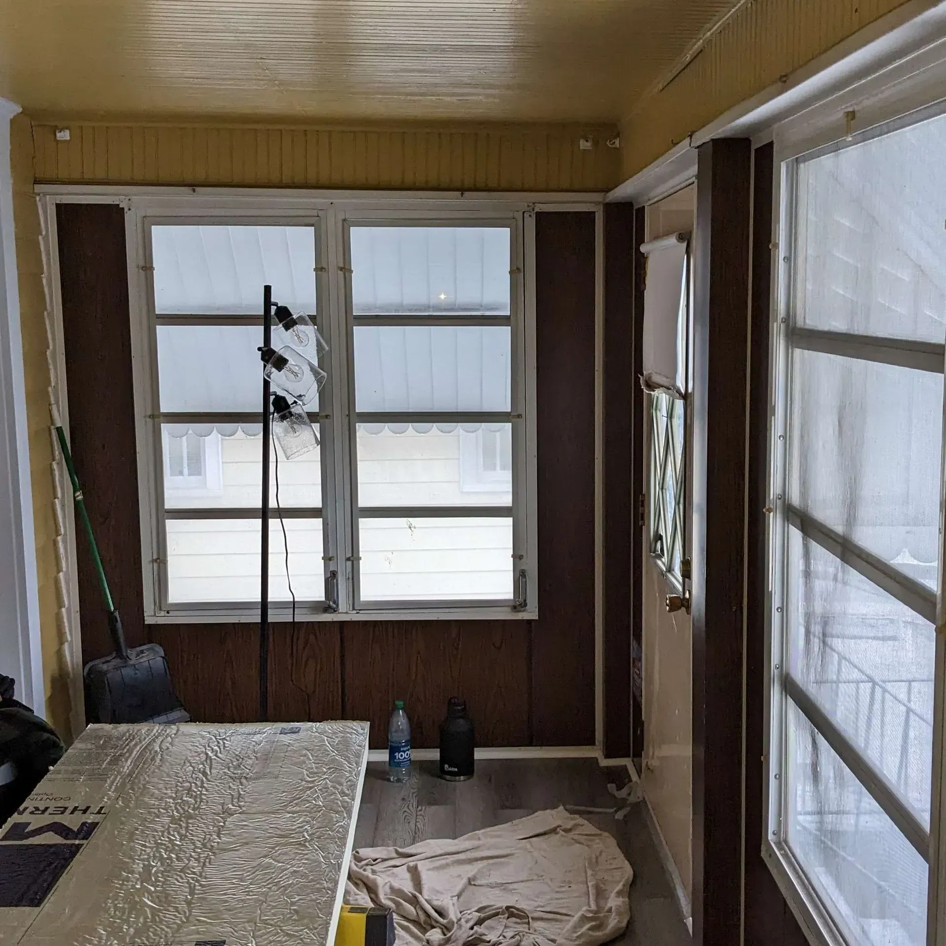 A room with a lot of windows and a table