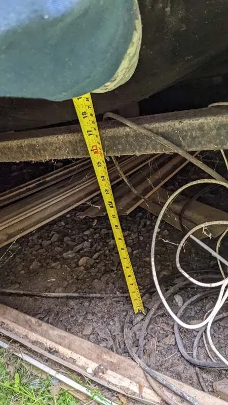 A tape measure is being used to measure the height of a vehicle.