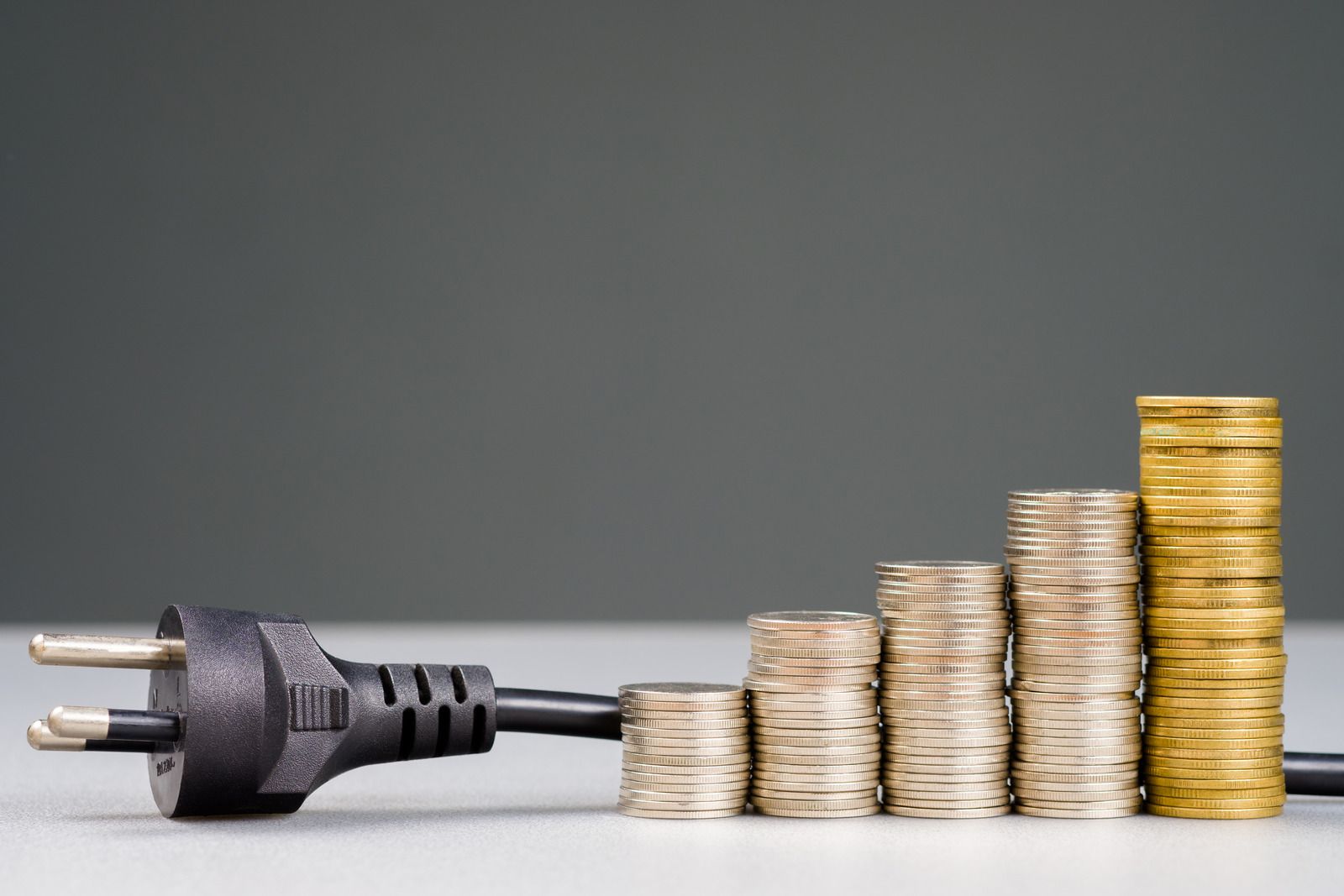 A light is shining through a hole in the ceiling of an attic.