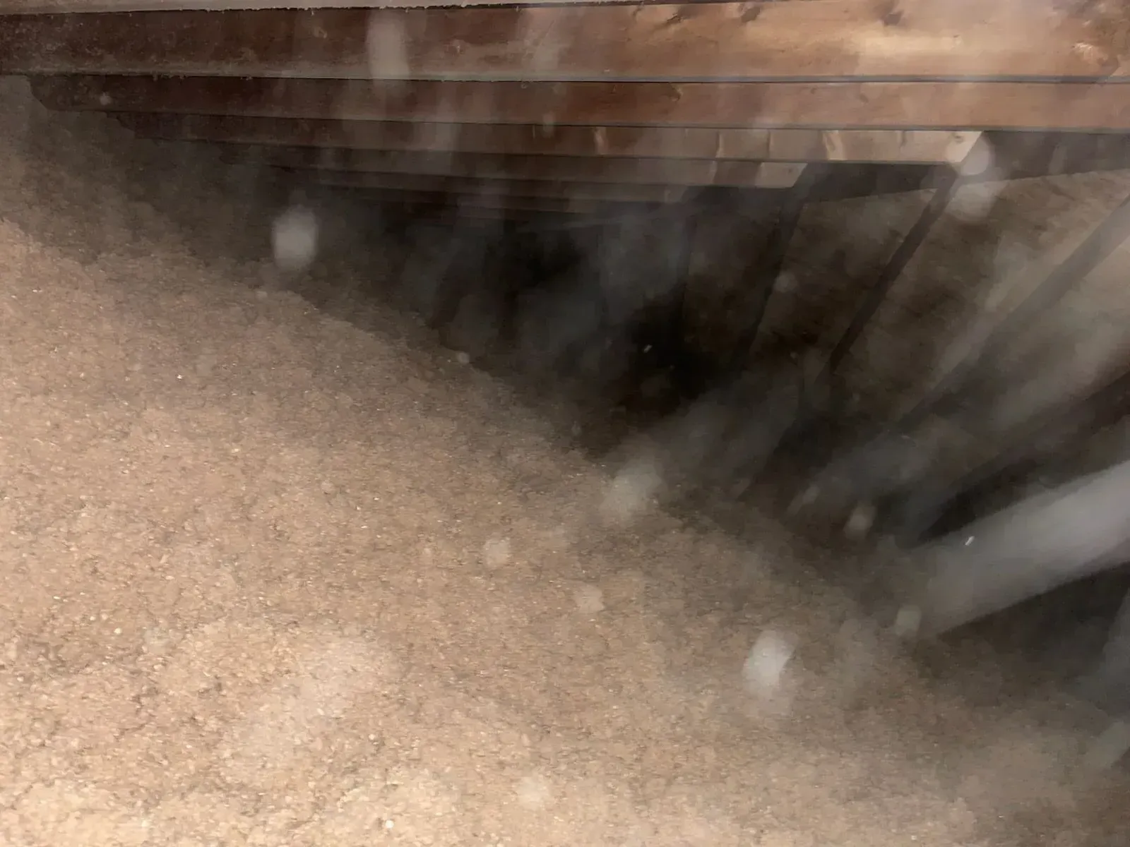 A close up of a pile of sand in a dark room.