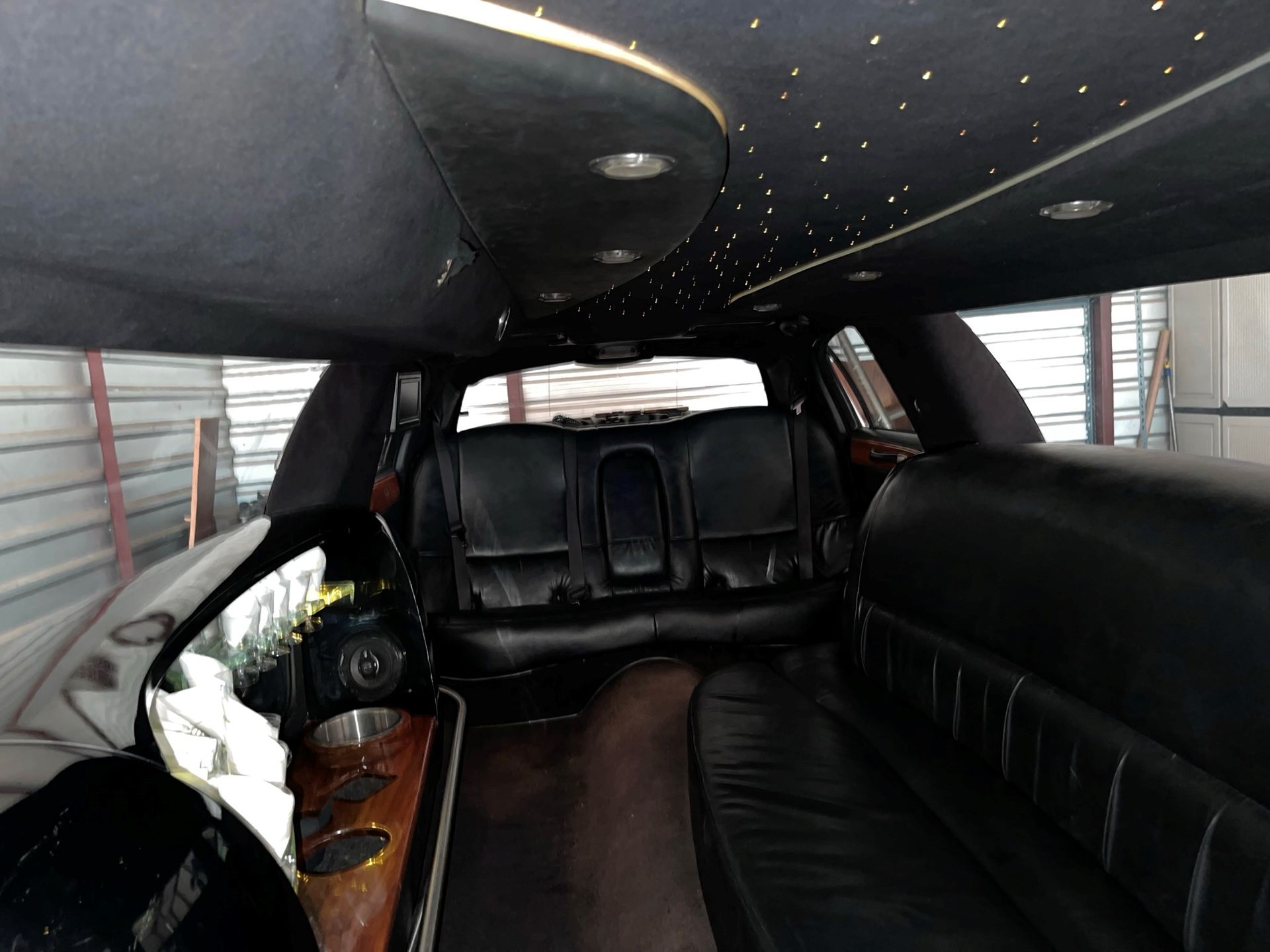 The inside of a black limousine with a black ceiling