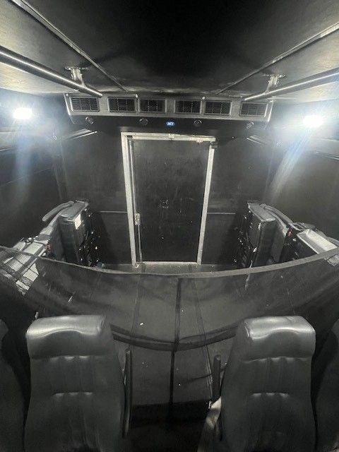 A dark room with a few lights on the ceiling