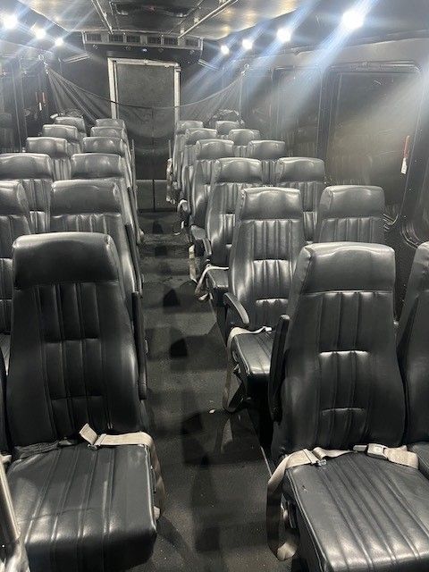 The inside of a bus with a lot of seats.