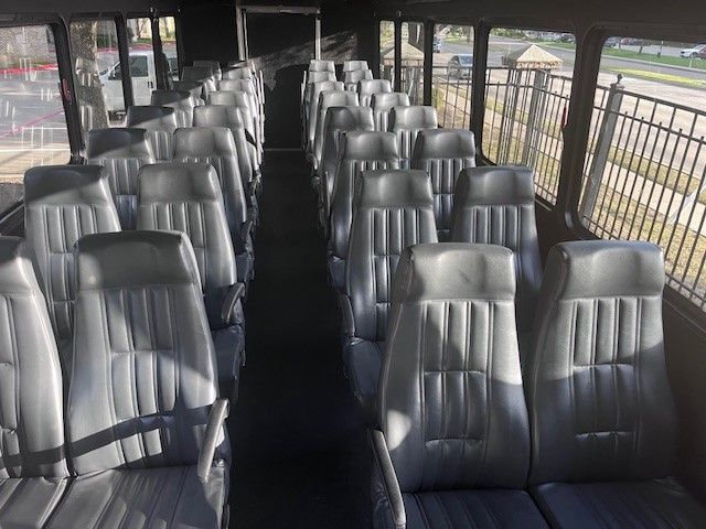 The inside of a bus with a lot of seats