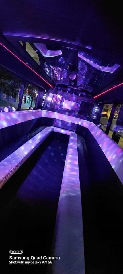 A picture of the inside of a limousine with purple lights.