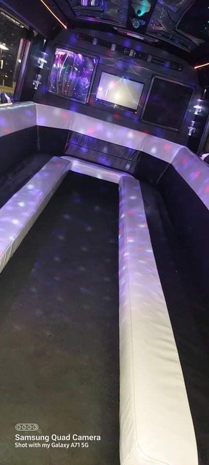 There is a long couch in the middle of the room.