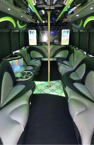 The inside of a limousine with a pole in the middle.
