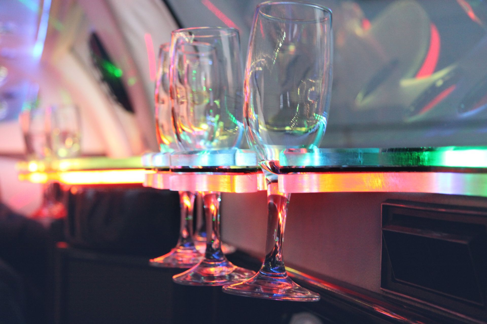 A row of wine glasses sitting on top of a table in a limousine.