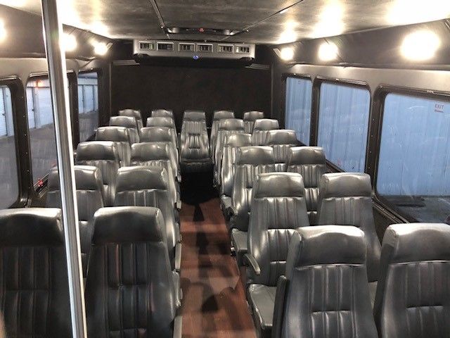 The inside of a bus with a lot of seats