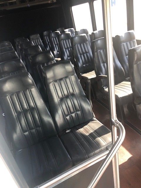 A row of black and white seats on a bus