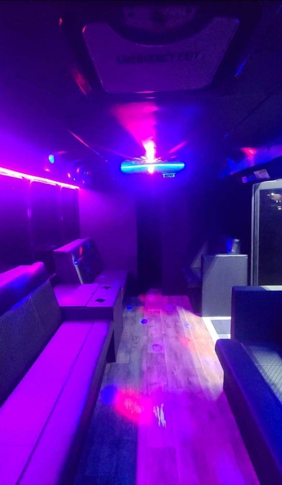 A room with purple lights on the walls and ceiling