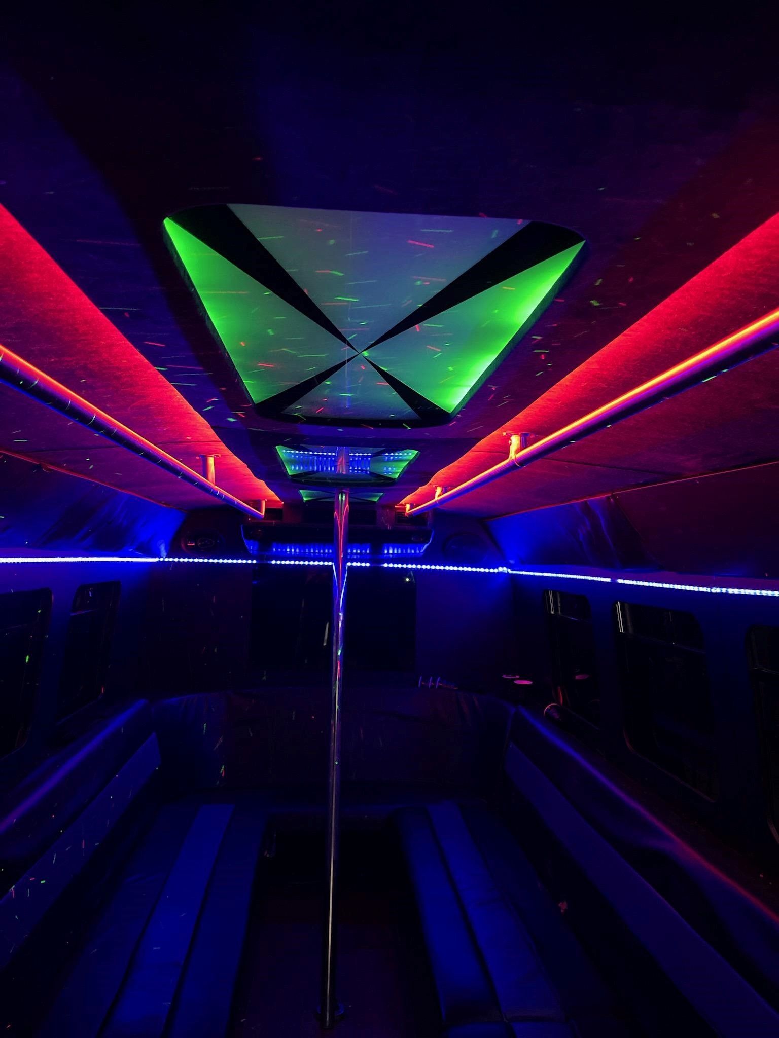 The inside of a limousine with a lot of lights on the ceiling.