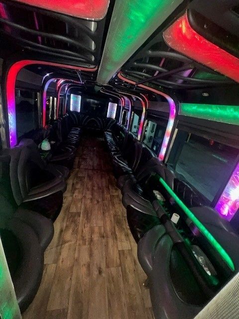 The inside of a limousine with lots of seats and lights.