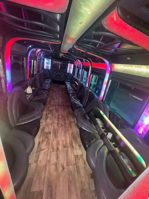 The inside of a limousine with a lot of seats and lights.