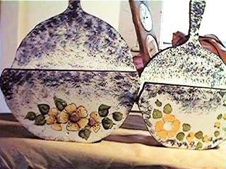 Two decorative ceramic bowls with lids, floral designs, speckled blue and white.