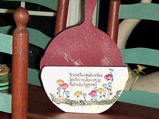 Wooden decorative scoop with floral painting and quote.