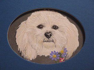 Oval painting of a white fluffy dog with dark eyes and a small bouquet of purple and pink flowers.