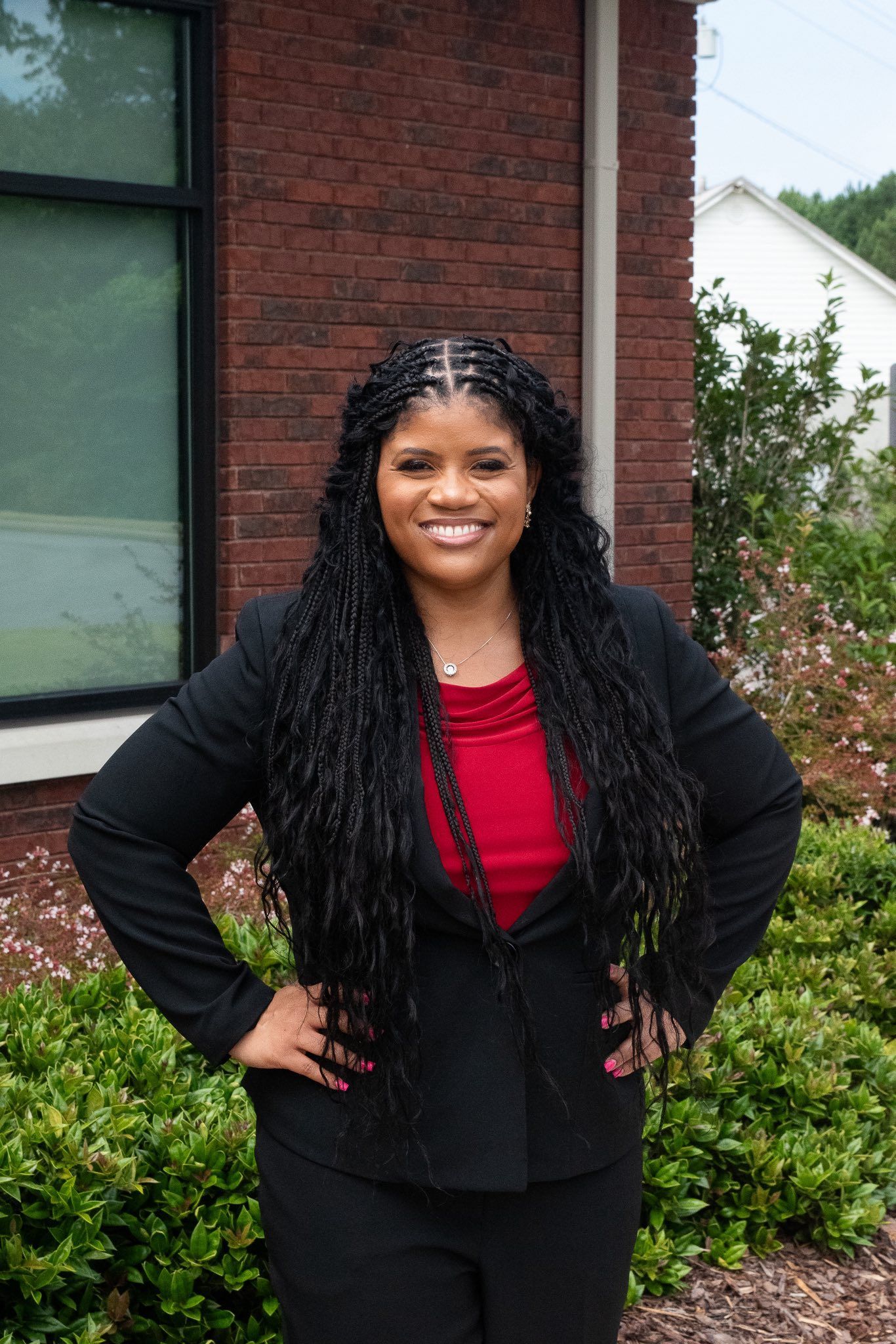 A woman in a black dress is standing on a set of stairs.