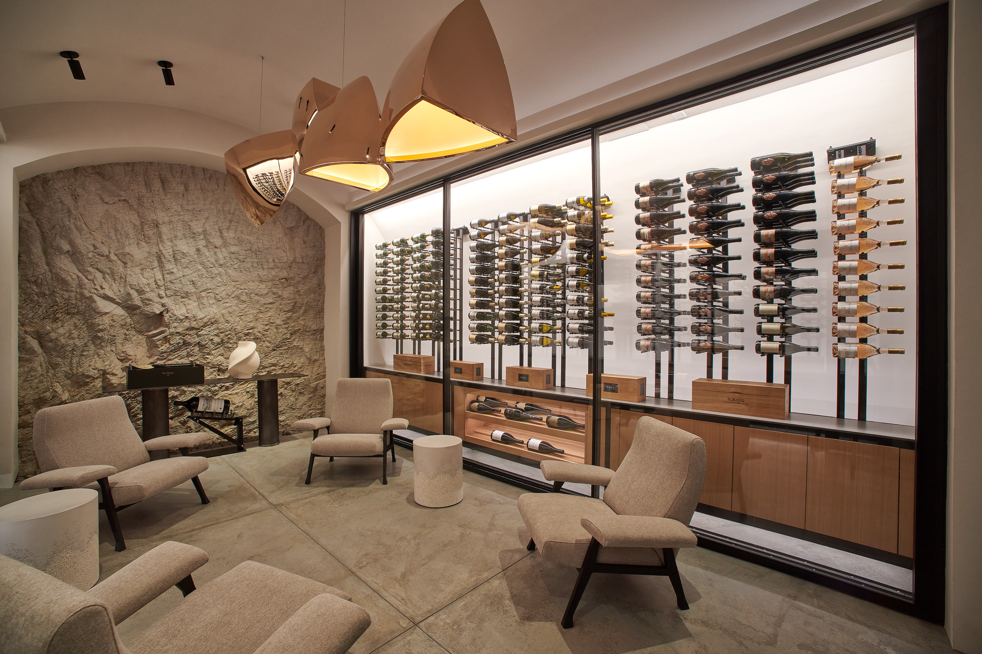 An optician's showroom with eyeglasses on display, seating area, and unique light fixtures.