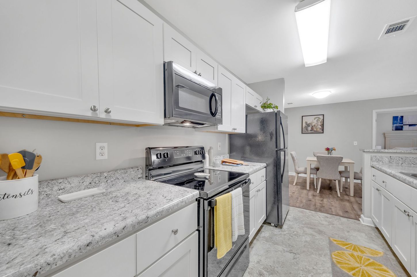 A kitchen with stainless steel appliances and granite counter tops.