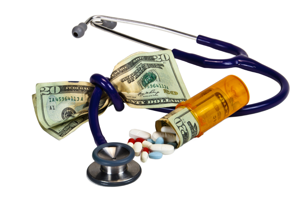 A stethoscope with money and pills on it