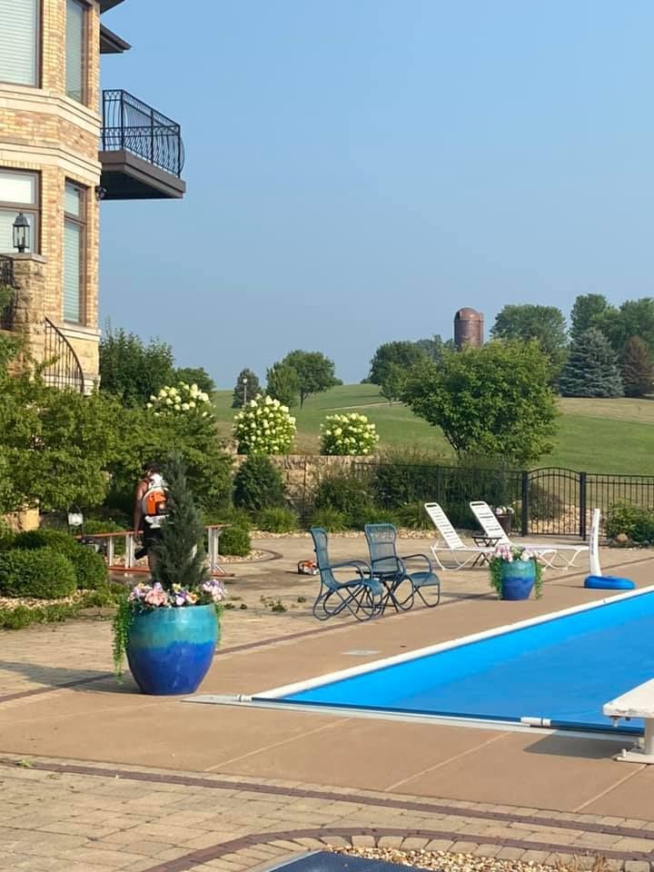 A large swimming pool in front of a large house