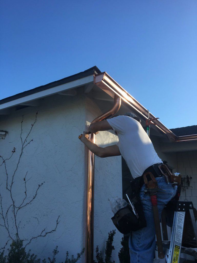 Man fixing gutter — Huntington Beach, CA — California Gutter Co, Inc.
