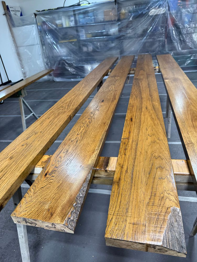 A row of wooden benches sitting on top of each other in a room.