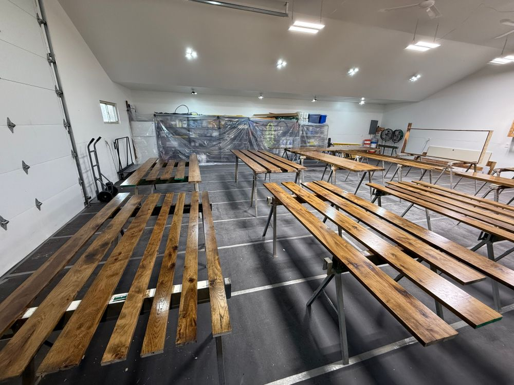 A room with a lot of wooden benches in it