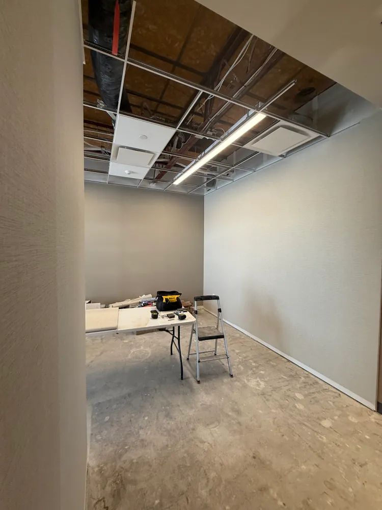 An empty room with a table and chairs in it.