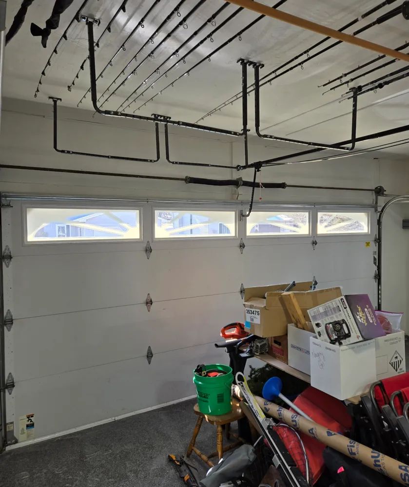 A garage filled with boxes and a green bucket