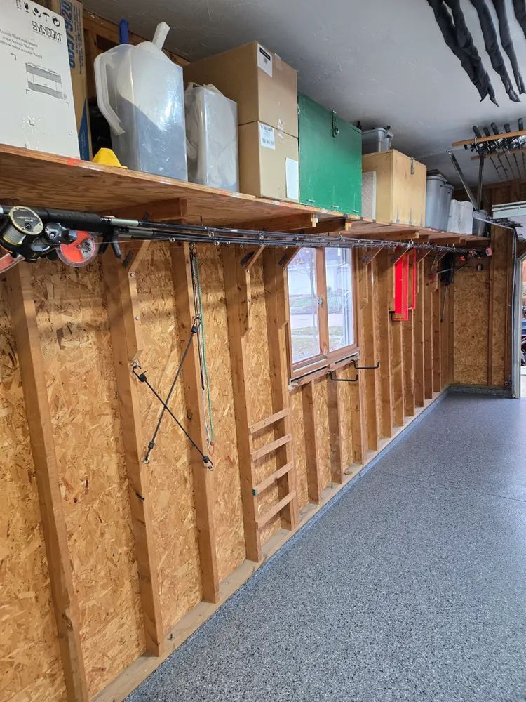 A garage with a lot of shelves and boxes on the wall.