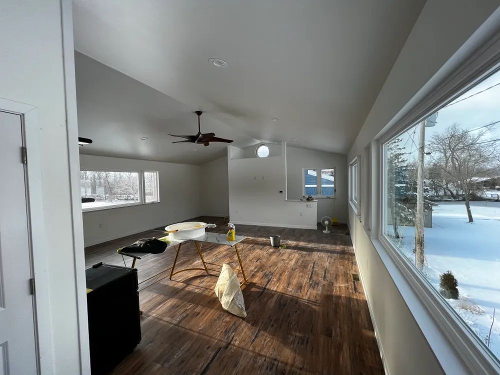 A living room with hardwood floors and a ceiling fan.