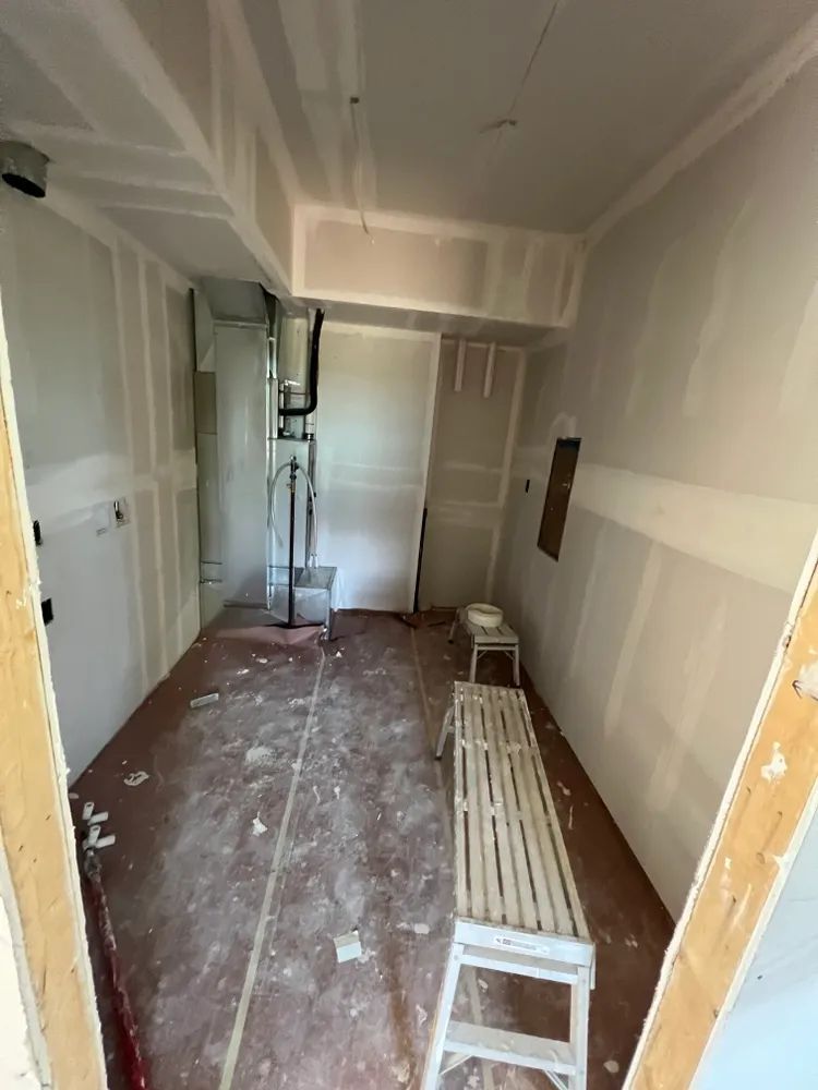 A room with a ladder and a bench in it.