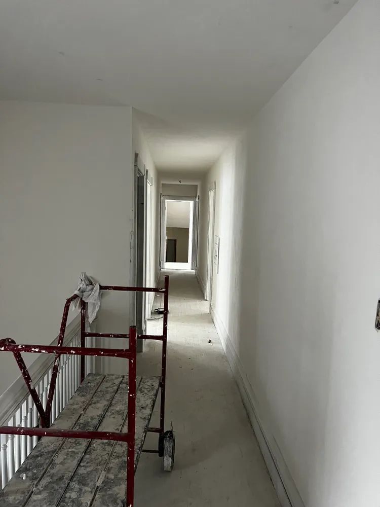A long hallway with a red cart in the middle