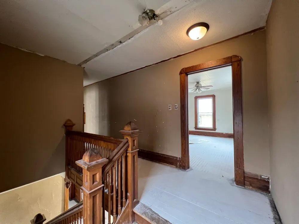 There is a staircase leading up to the second floor of a house.