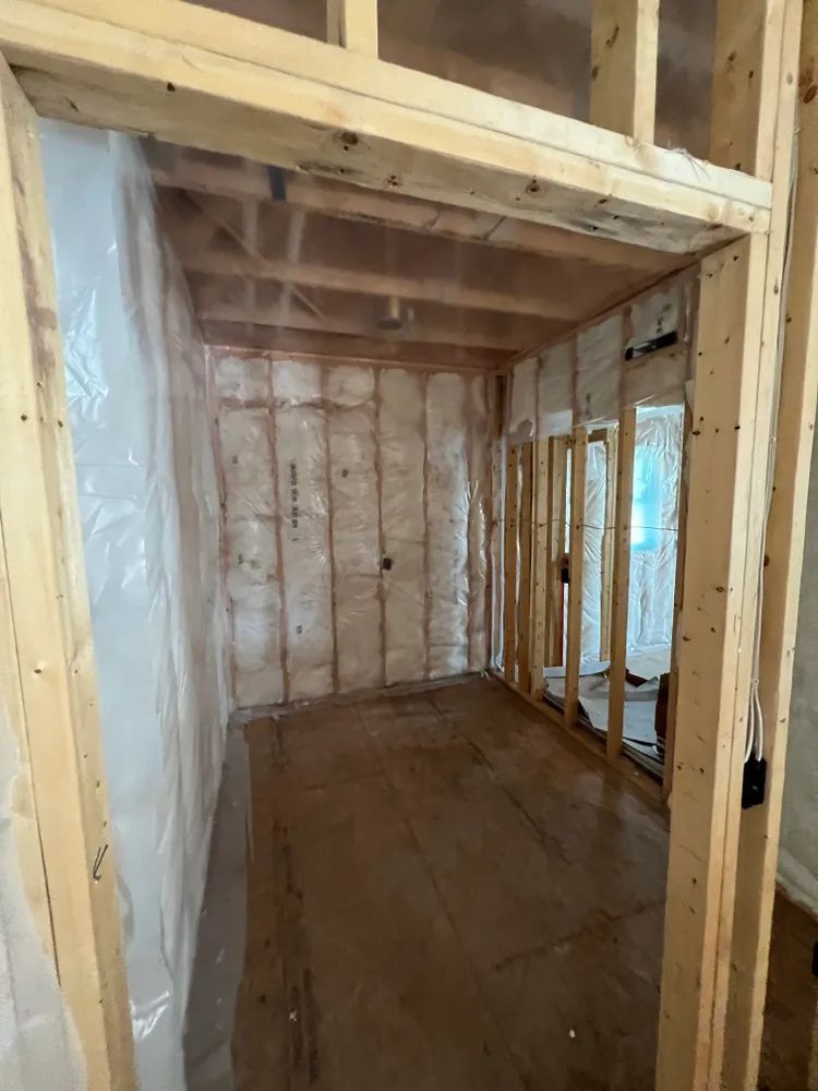 A room with wooden walls and a wooden floor is being built.