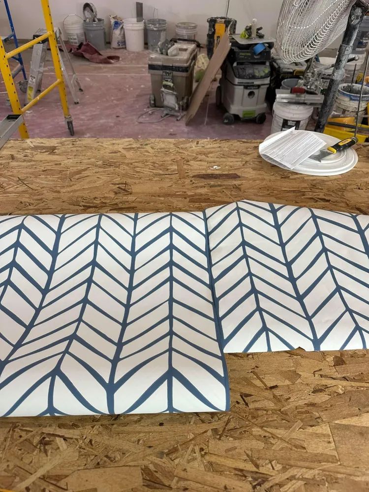 A wooden table with a blue and white chevron pattern on it.