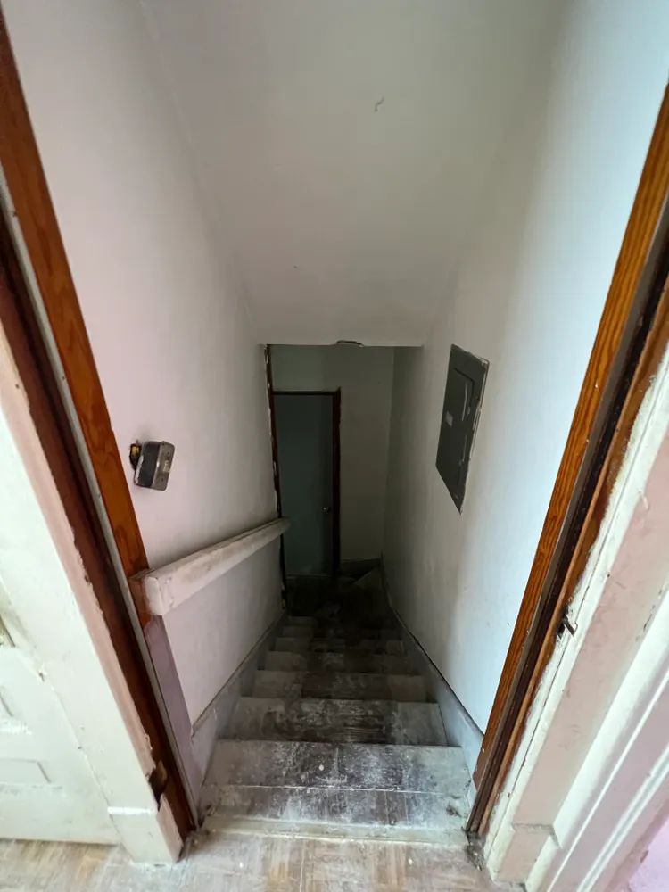 A set of stairs leading up to a basement in a house.